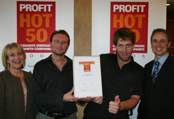 Four people at the 2006 PROFIT HOT 50 event holding a framed award certificate for Lifecapture Media