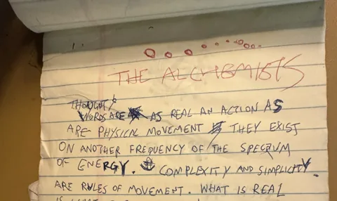 Yellow notepad page titled The Alchemists, handwritten philosophy
